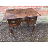 A George III mahogany crossbanded lowboy, circa 1770, triple oak lined frieze drawers with brass