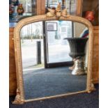 A Victorian gilt gesso over mantle mirror, foliate floral finial, the rounded rectangular frame with