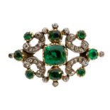 A Victorian diamond and emerald set brooch, comprising a cushion cut emerald set to the centre, size