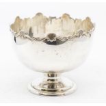 A George V silver rose bowl on stand, cast wavy rocaille and scroll border on raised foot, by Mappin