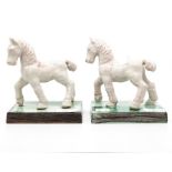 A pair of Spanish tin glazed figures of horses, one has tail repair