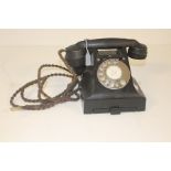 A black bakelite telephone, circa 1950