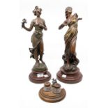 Two spelter lady figures on wooden stands, French along with an ink stand