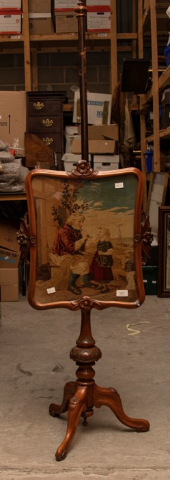 A Victorian fire screen with wool work of fisher woman and young girl