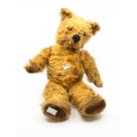 A mid 20th Century vintage teddy bear foam and straw filled