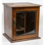 An early 20th century oak smokers cabinet, with key, circa 1910, height approx. 31cm.