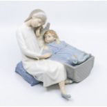 Nao figure of young girl next to son or brother in cot