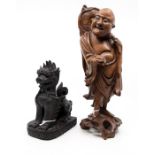 A Chinese carved fruitwood figure of a deity possibly Bodhidharma and an ebonised carving of a