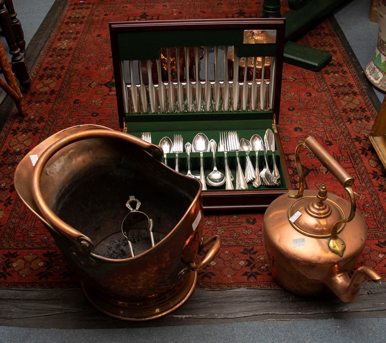 A Butler of Sheffield mahogany cased canteen of flatware; a copper kettle and coal scuttle (3)