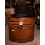 A mid 20th Century bowler hat in metal hat tin, size medium, in good overall condition