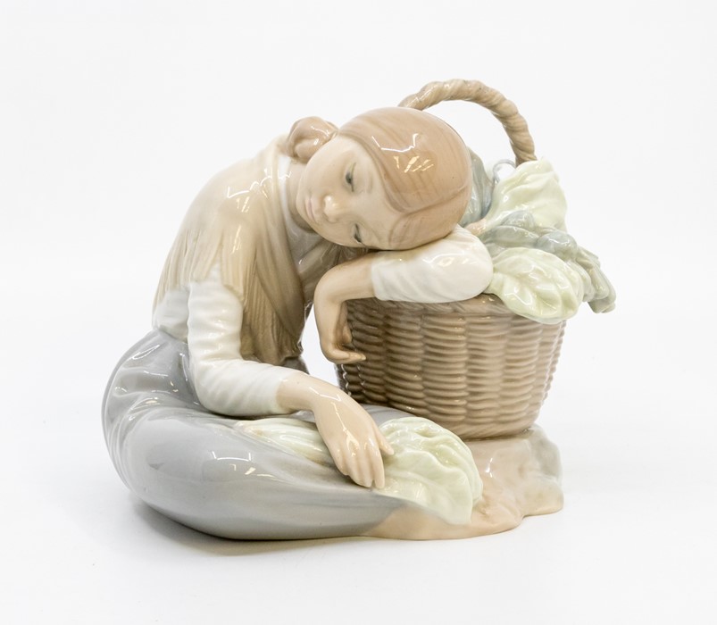 A Lladro figure of a girl leaning on a basket of cabbages Condition: repair of basket handle but not