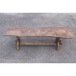 Nigel Griffiths oak coffee table of rustic design, the naturalistic top raised on a trestle type