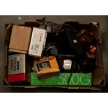 A collection of cameras and equipment including Halina, Kodak, along with binoculars and boxed