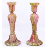A pair of early 20th Century multi coloured glass candlesticks, hand blown
