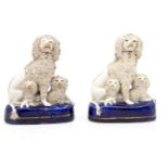 Two small Staffordshire figures of poodles and puppies on blue bases, late 19th Century