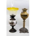 An Edwardian brass oil lamp with yellow shade; and another oil lamp (2)