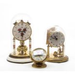 Two German anniversary dome clocks, along with Europa mantle travel clock