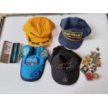 Assorted. 4 x F1 team crew caps. new , along with a 2005 F1 team cased pen, and 30+ button badges.