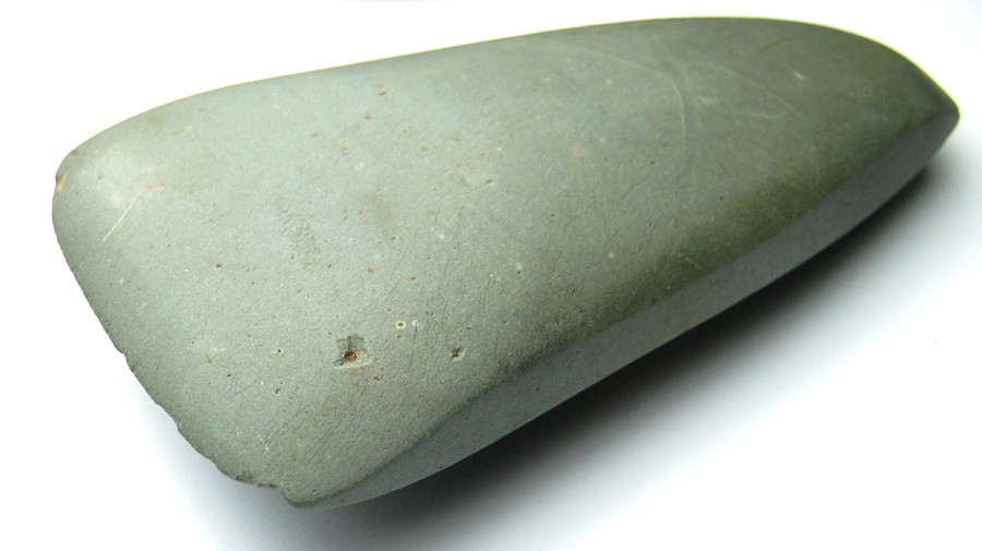 Neolithic polished greenstone axehead. A ground and polished Neolithic axehead c. 4000BC - 3000BC.