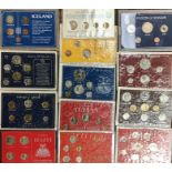 Large collection of UK & World coin sets nearly all sealed in original packaging. In a pink metal