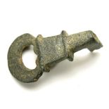 Roman Bronze Key.   Circa 2nd century AD. Size: 34.84 mm. A cast bronze key consisting of a crescent