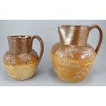 Two mid-nineteenth century brown salt glazed stoneware jugs, c.1840.  Both are decorated with