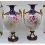 A pair of large Royal Bonn twin-handled vases, painted with colourful poppies, gilded, on