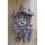 A twentieth century black forest-type cuckoo clock with weights. Minor damages and losses.