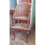 A nineteenth century child's high chair with wicker sides and stands upon a base section on cabriole