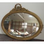 An oval gilt framed mirror with oak and laurel leaf decoration. 85cm wide