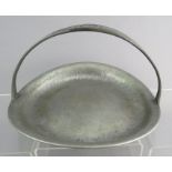 A Tudric arts and crafts footed dish with strap handle, hammered finish, marked to the underside. 25