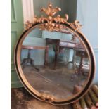 A wall hanging mirror of large proportions with ornate frame and black inner details. 111cm wide.