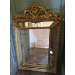 A nineteenth century gilt mirror, rococo design, scrolling carved top, with foliage carving