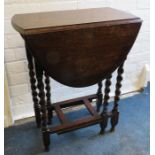 A 1920's oak oval gate leg table with barley twist under frame. 61cm wide Provenance: From The Sadia