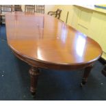 A Victorian Revival mahogany dining room table with extra leaves, four in total. 3.36m with three