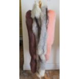 A collection of long fur stoles to include a pink dyed fox fur stole by Kensington and a silver