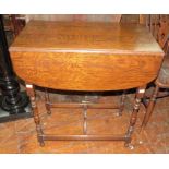 A small oak gate leg table, drop leaf style. 69 cm wide.