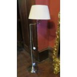 A modern brass standard lamp with shade.