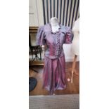 A mauve watered taffeta two piece bridesmaid's dress which was used/made in WWII. The bodice is