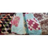 A late 1930s early 1940s turquoise background quilt with squares of assorted colourways of patchwork
