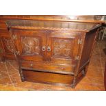 An early twentieth century oak sideboard with doors on canted ends. 120 cm wide.