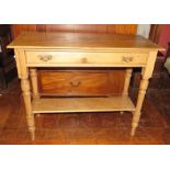 An early twentieth century pine table, two drawers and a shelf. 91cm wide.