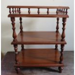 A Victorian three-tier display shelf with gallery and turned bobbin-type uprights. 51 cm tall.