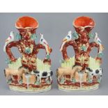 Two ate nineteenth century Staffordshire spill vases groups, c. 1860-1870. They both depict horses
