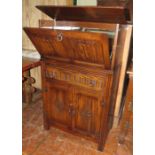 An early twentieth century oak drinks cabinet with drop front and with glass shelf etc. 75cm wide