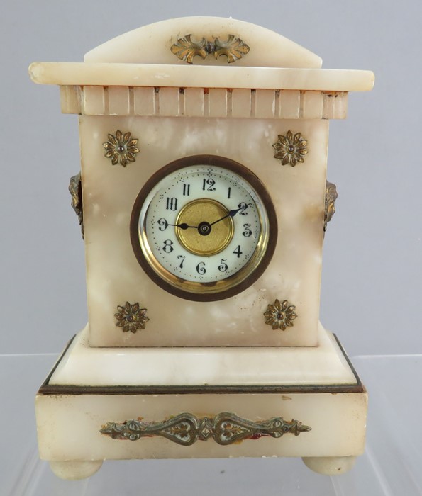 A small size alabaster type bracket clock with ormolu mounts. 19 cm tall.  Some damages.