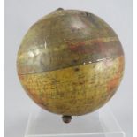 A tin biscuit barrel in the form of a globe. With hinged lid and standing on four feet. Some wear