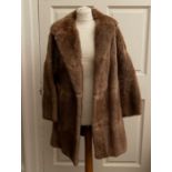 A 3/4 Mid Brown Musquash 3/4 coat and a white Artic fox stole and fur collar (3) Lining has been