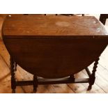 A George III oak gate leg dining table with barley twist legs