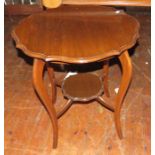 A circular mahogany side table with shaped top. 60 cm wide.
